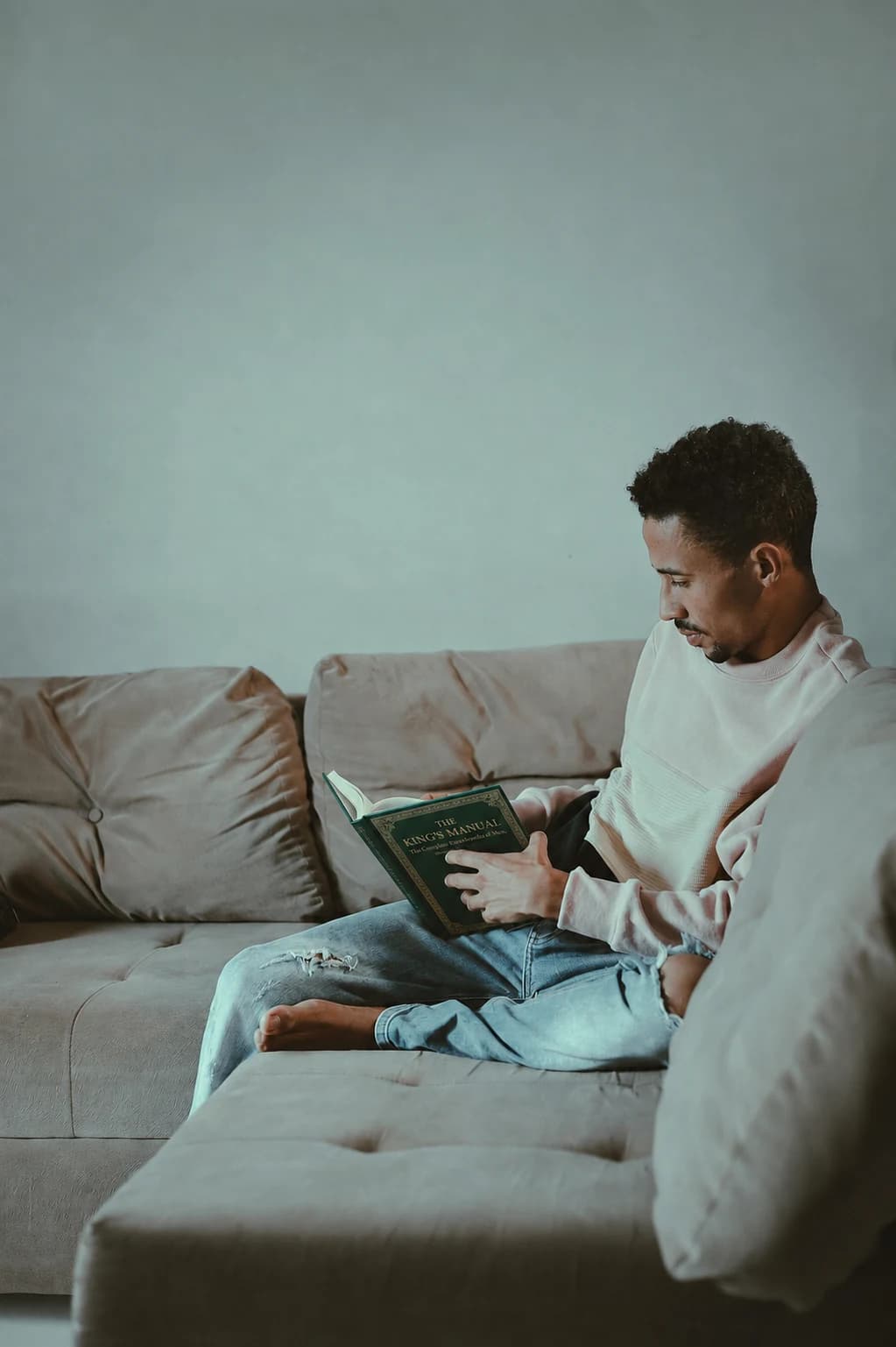 A reader looking through The King's Manual Volume III